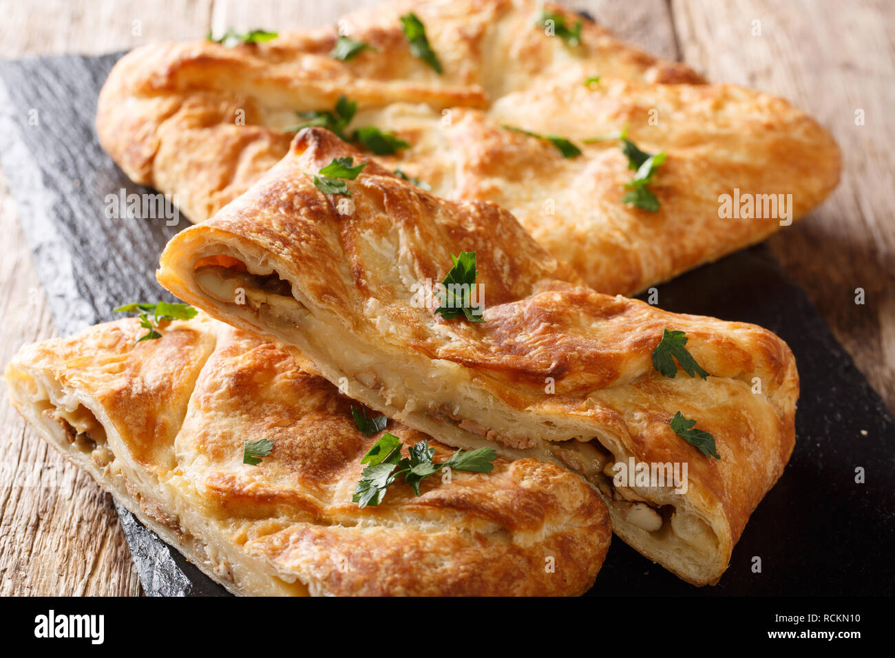 Khachapuri is a traditional Georgian dish of cheese-filled bread. The filling contains cheese sulguni, eggs and other ingredients Stock Photo