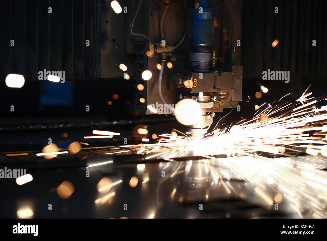 Sparks fly out machine head for metal processing Stock Photo