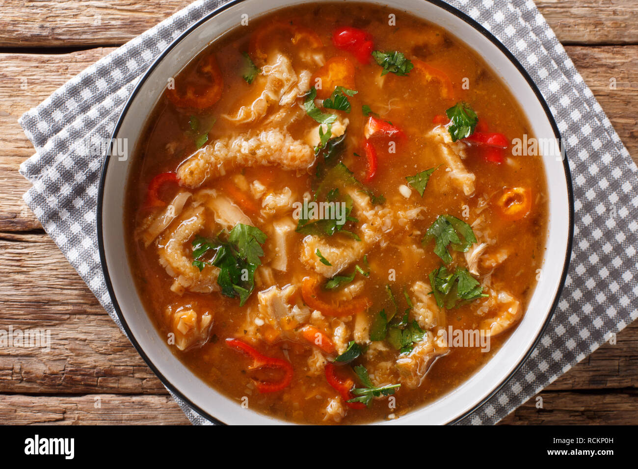 Flaki or flaczki is a traditional Polish meat stew close-up in a bowl on the table. horizontal top view from above Stock Photo
