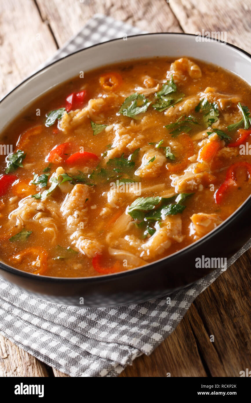 Polish national cuisine. flaczki with vegetables in tomato sauce close-up in a bowl on the table. vertical Stock Photo