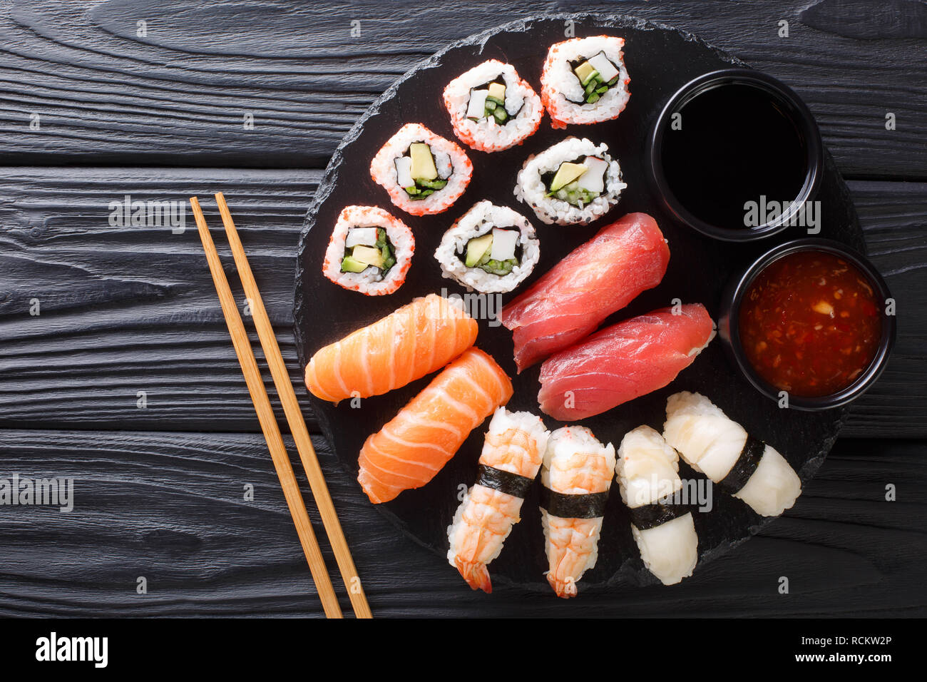 Japanese sushi food. Maki ands rolls with tuna, salmon, shrimp, crab and with two sauces on a plate. horizontal top view from a Stock Photo - Alamy