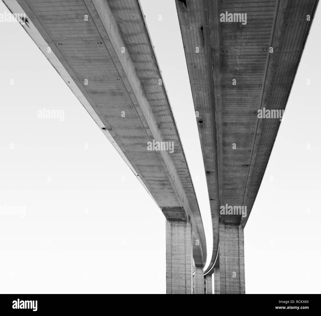 View from underneath large scale road bridge, black and white Stock Photo