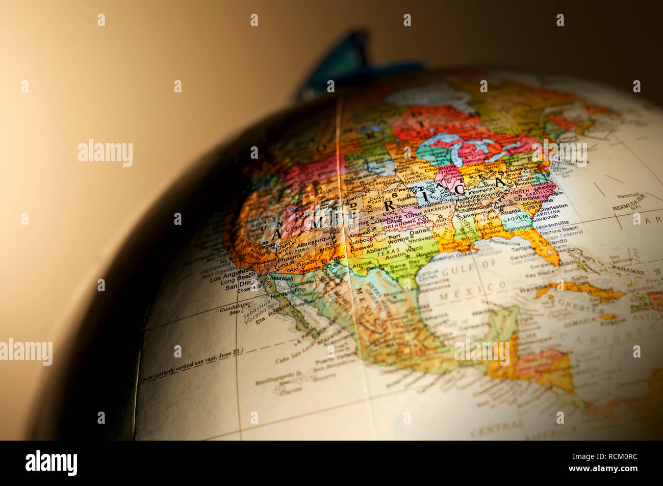 Globe showing details of the Americas, close up, cropped, plain background, brown background Stock Photo