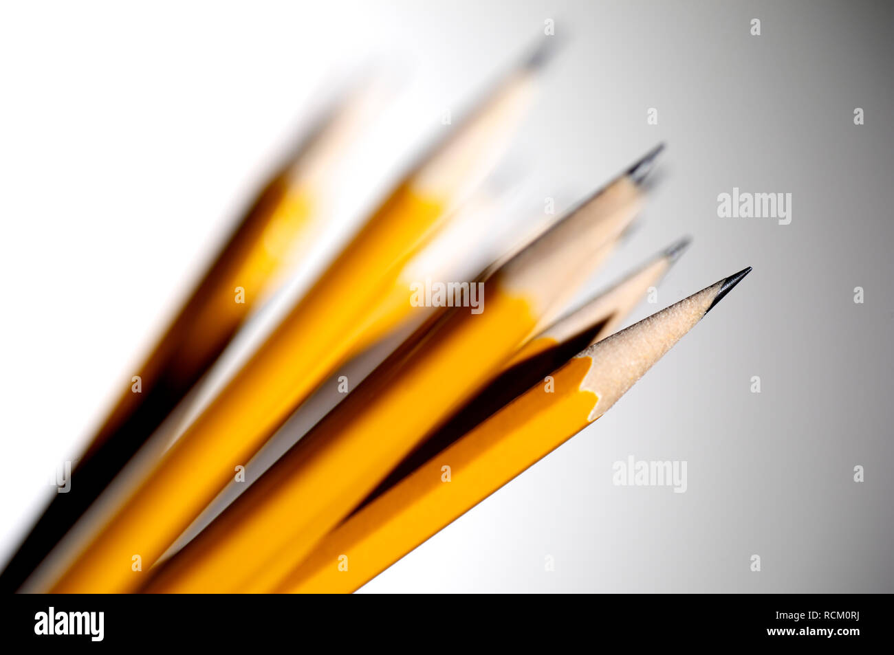 Yellow pencils, differential focus, close up, grey background Stock Photo