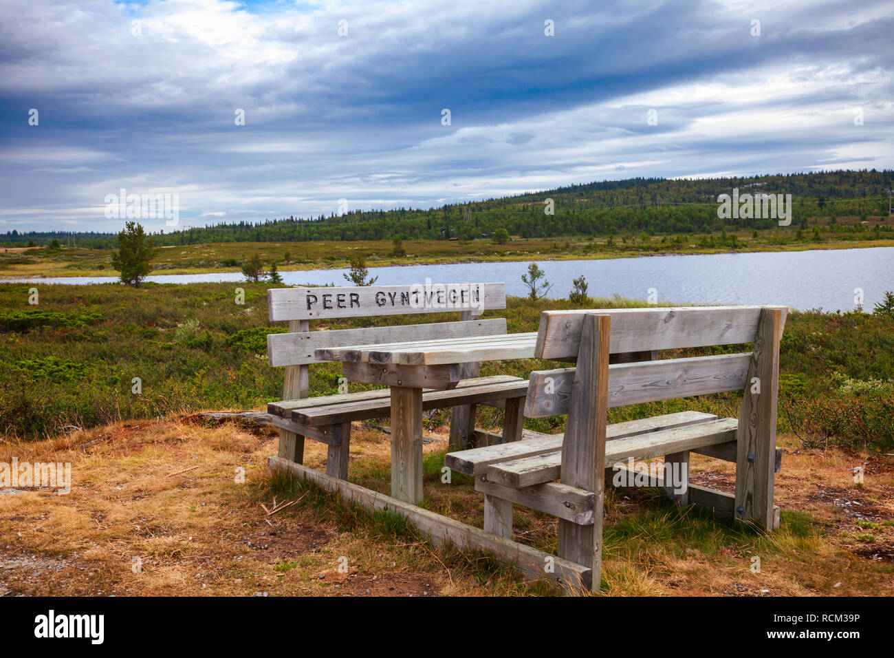 Wooden picnic table with engraved name of Peer Gynt Vegen, a scenic tourist mountain toll road named after the folk character Peer Gynt in Oppland Cou Stock Photo