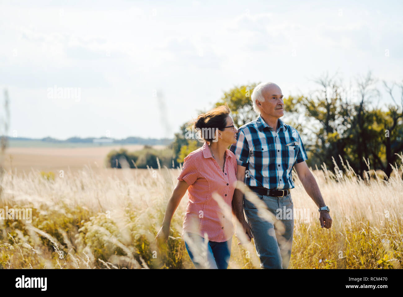 Senior couple walking down a path in nature Stock Photo