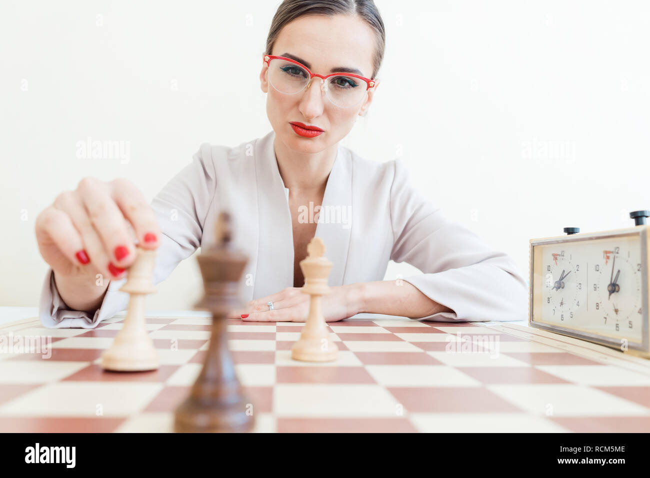 Making A Move Chess Hand holding chess piece hi-res stock photography and images - Alamy