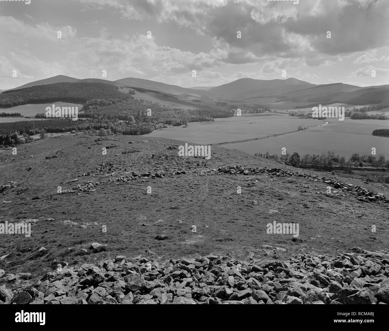 View SW over two stone ramparts & external chevaux-de-frise (defensive setting of upright stones) of Dreva Craig Iron Age hillfort, Scottish Borders. Stock Photo