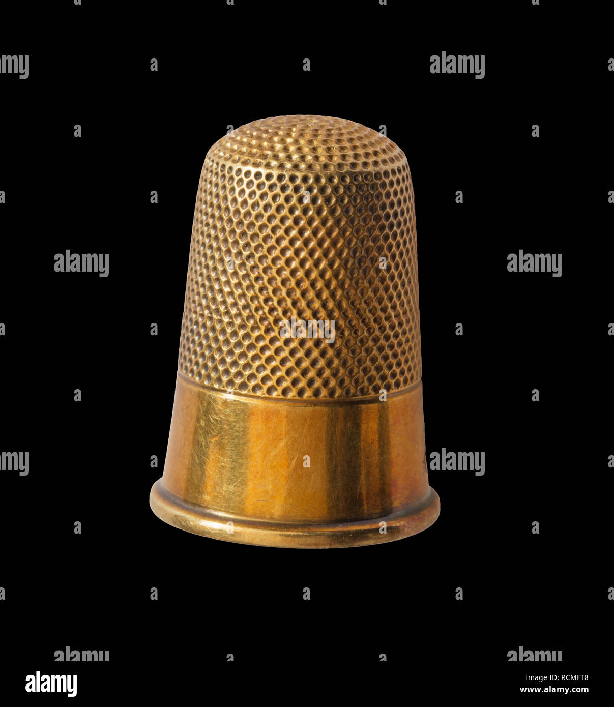 close up of brass thimble isolated on black background Stock Photo