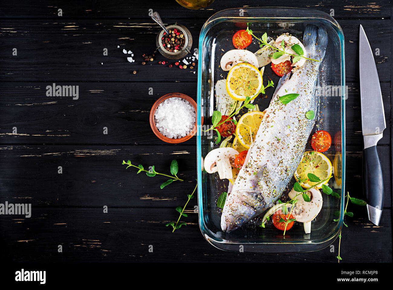 Raw fish. Sea bass on baking dish. Ingredients for cooking, grill