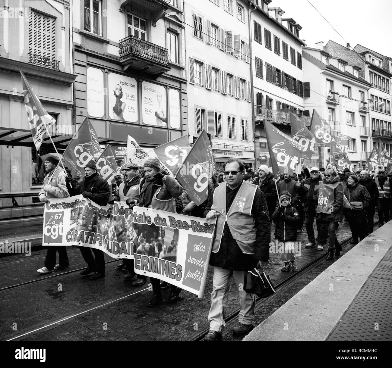 STRASBOURG, FRANCE - MAR 22, 2018: Side view of CGT General Confederation of Labour workers with placard at demonstration protest against Macron French government string of reforms - black and white  Stock Photo