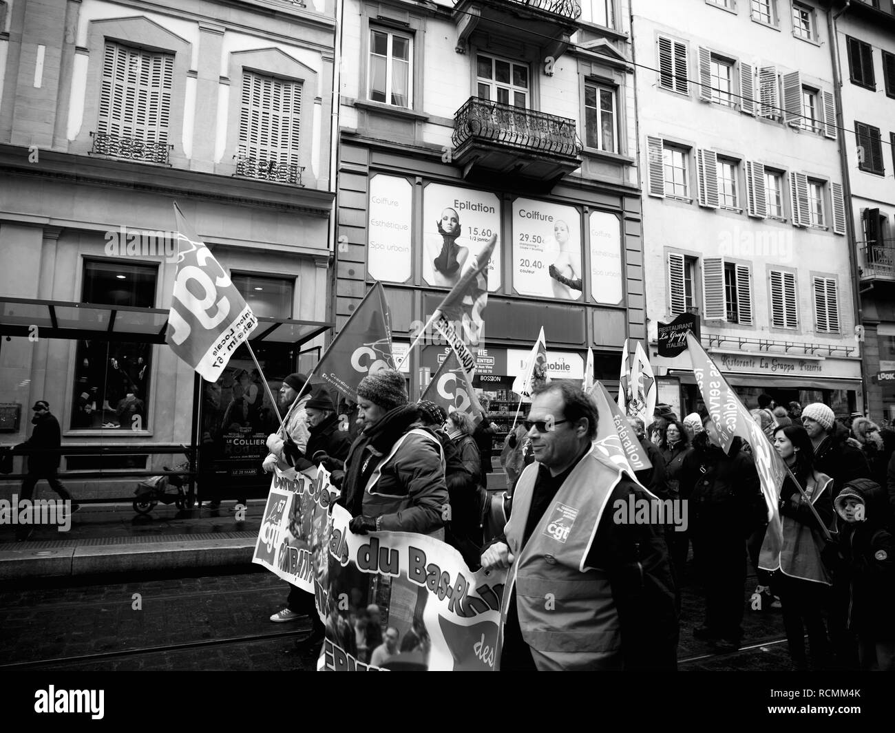 STRASBOURG, FRANCE - MAR 22, 2018: Side view of CGT General Confederation of Labour workers with placard at demonstration protest against Macron French government string of reforms - black and white  Stock Photo
