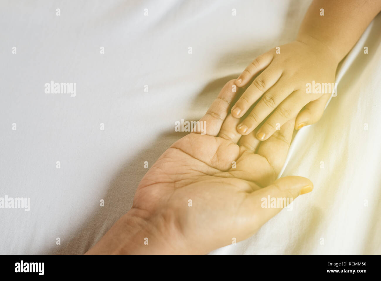 close up of mother and daughter holding hands. concept of family, motherhood and togetherness Stock Photo