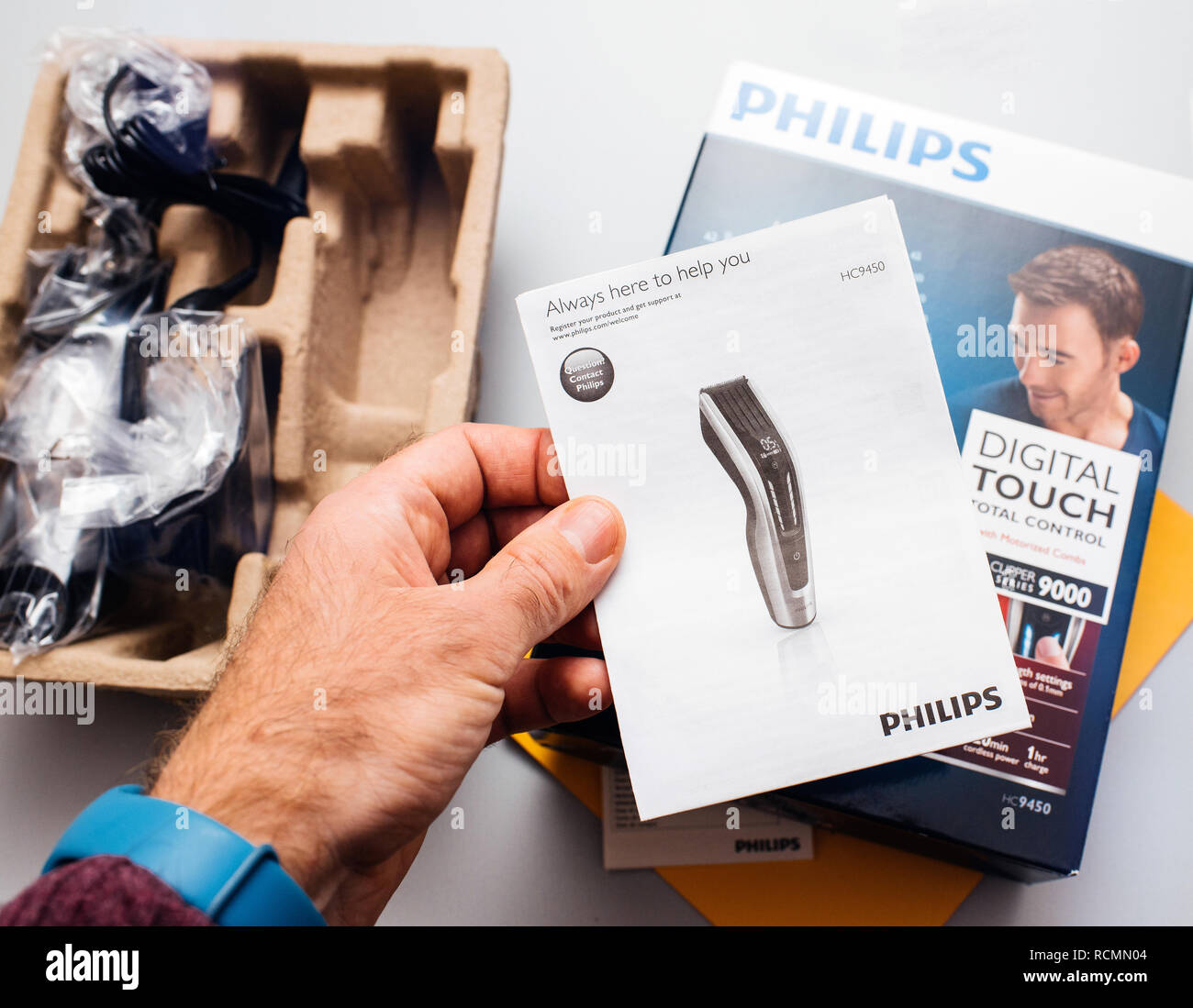 PARIS, FRANCE - FEB 14, 2018: Man unboxing Philips Hair Clipper Series 9000 Professional digital clipper for home use with professional results with motorized combs  Stock Photo