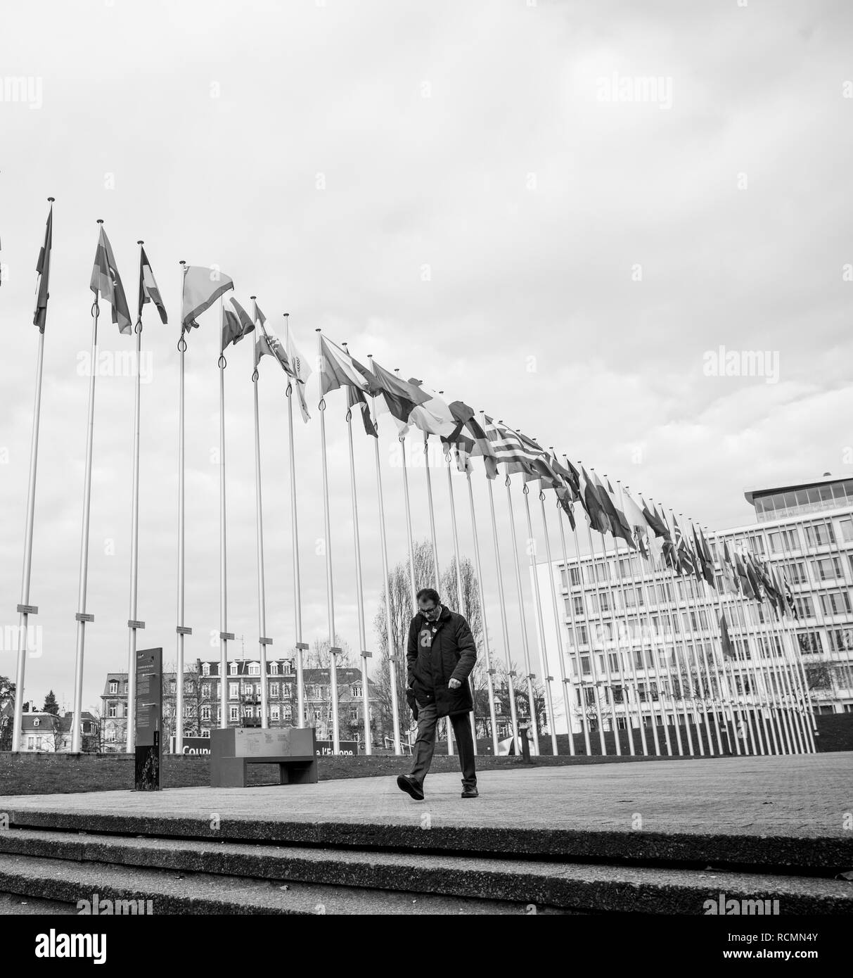STRASBOURG, FRANCE - MAR 29, 2018: Worker under Flag of Russia flying half-mast at Council of Europe as a tribute and mourning victims of fire at Zimnyaya Vishnya shopping centre Kemerovo Stock Photo