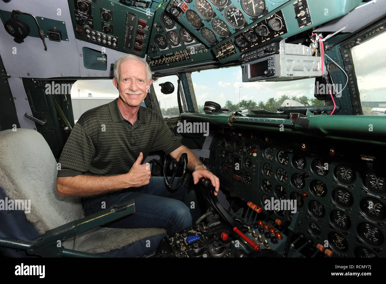 MIAMI, FL - NOVEMBER 17: Captain 'Sully' Sullenberger and Co-pilot Jeff Skiles pose with the Historical 1958 DC7 for a benefit hosted by Historical Flight Foundation. Chesley Burnett 'Sully' Sullenberger, III (born January 23, 1951) is a retired airline captain and aviation safety consultant. He was hailed as a national hero in the United States when he successfully executed an emergency water landing of US Airways Flight 1549 in the Hudson River off Manhattan, New York City, after the aircraft was disabled by striking a flock of Canada geese during its initial climb out of LaGuardia Airport o Stock Photo