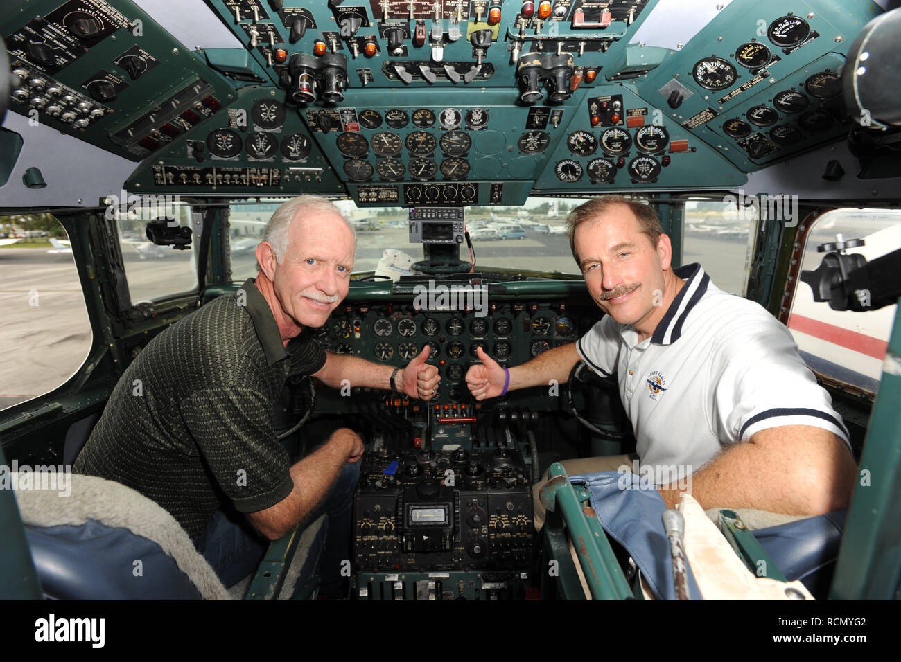 MIAMI, FL - NOVEMBER 17: Captain 'Sully' Sullenberger and Co-pilot Jeff Skiles pose with the Historical 1958 DC7 for a benefit hosted by Historical Flight Foundation. Chesley Burnett 'Sully' Sullenberger, III (born January 23, 1951) is a retired airline captain and aviation safety consultant. He was hailed as a national hero in the United States when he successfully executed an emergency water landing of US Airways Flight 1549 in the Hudson River off Manhattan, New York City, after the aircraft was disabled by striking a flock of Canada geese during its initial climb out of LaGuardia Airport o Stock Photo