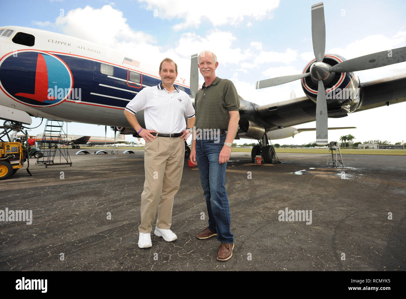 MIAMI, FL - NOVEMBER 17: Captain 'Sully' Sullenberger and Co-pilot Jeff Skiles pose with the Historical 1958 DC7 for a benefit hosted by Historical Flight Foundation. Chesley Burnett 'Sully' Sullenberger, III (born January 23, 1951) is a retired airline captain and aviation safety consultant. He was hailed as a national hero in the United States when he successfully executed an emergency water landing of US Airways Flight 1549 in the Hudson River off Manhattan, New York City, after the aircraft was disabled by striking a flock of Canada geese during its initial climb out of LaGuardia Airport o Stock Photo