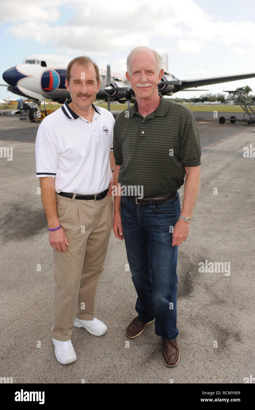 MIAMI, FL - NOVEMBER 17: Captain 'Sully' Sullenberger and Co-pilot Jeff Skiles pose with the Historical 1958 DC7 for a benefit hosted by Historical Flight Foundation. Chesley Burnett 'Sully' Sullenberger, III (born January 23, 1951) is a retired airline captain and aviation safety consultant. He was hailed as a national hero in the United States when he successfully executed an emergency water landing of US Airways Flight 1549 in the Hudson River off Manhattan, New York City, after the aircraft was disabled by striking a flock of Canada geese during its initial climb out of LaGuardia Airport o Stock Photo