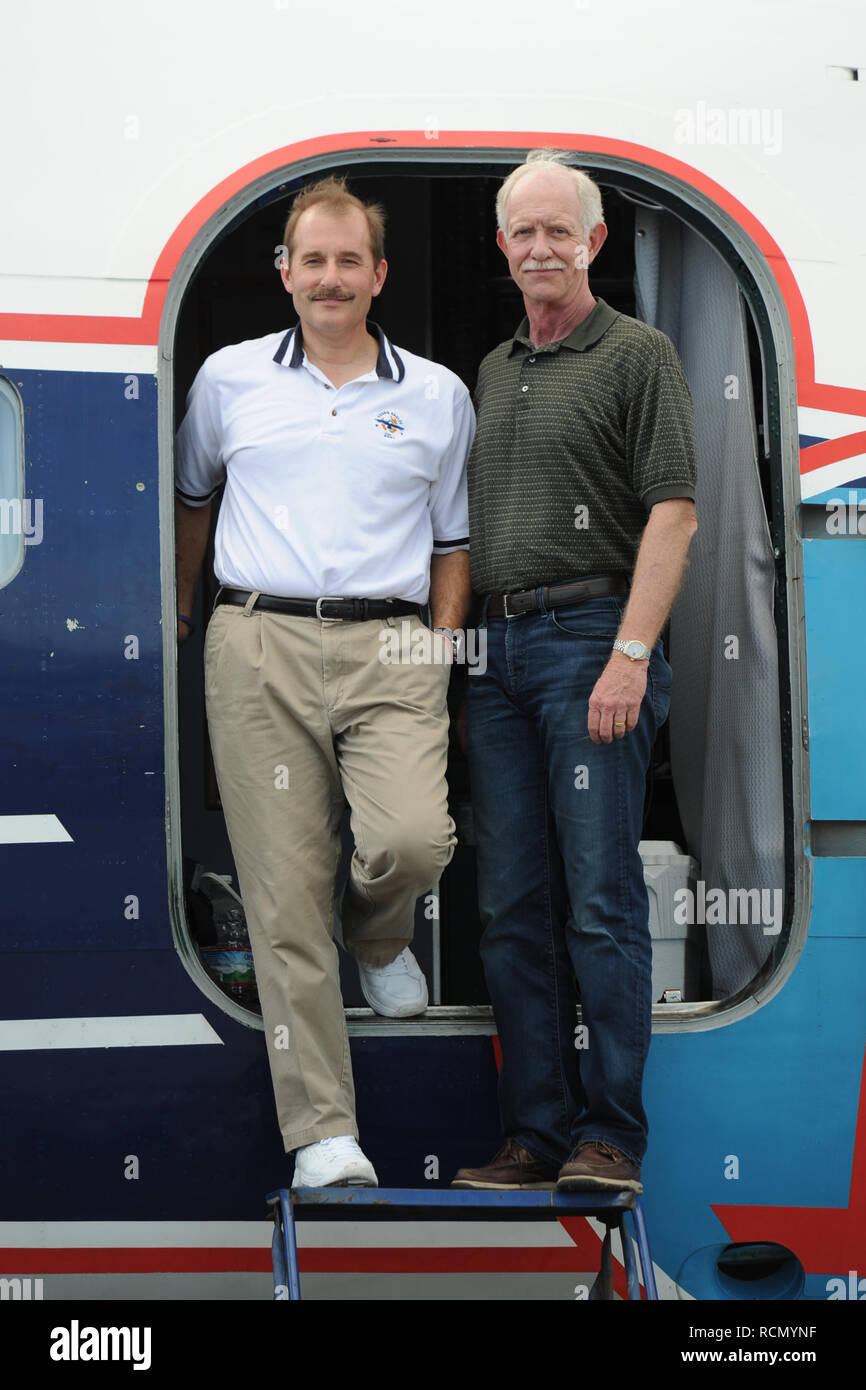 MIAMI, FL - NOVEMBER 17: Captain 'Sully' Sullenberger and Co-pilot Jeff Skiles pose with the Historical 1958 DC7 for a benefit hosted by Historical Flight Foundation. Chesley Burnett 'Sully' Sullenberger, III (born January 23, 1951) is a retired airline captain and aviation safety consultant. He was hailed as a national hero in the United States when he successfully executed an emergency water landing of US Airways Flight 1549 in the Hudson River off Manhattan, New York City, after the aircraft was disabled by striking a flock of Canada geese during its initial climb out of LaGuardia Airport o Stock Photo