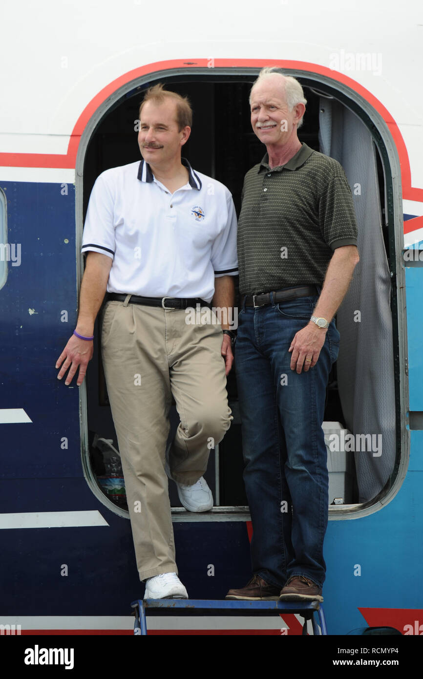 MIAMI, FL - NOVEMBER 17: Captain 'Sully' Sullenberger and Co-pilot Jeff Skiles pose with the Historical 1958 DC7 for a benefit hosted by Historical Flight Foundation. Chesley Burnett 'Sully' Sullenberger, III (born January 23, 1951) is a retired airline captain and aviation safety consultant. He was hailed as a national hero in the United States when he successfully executed an emergency water landing of US Airways Flight 1549 in the Hudson River off Manhattan, New York City, after the aircraft was disabled by striking a flock of Canada geese during its initial climb out of LaGuardia Airport o Stock Photo