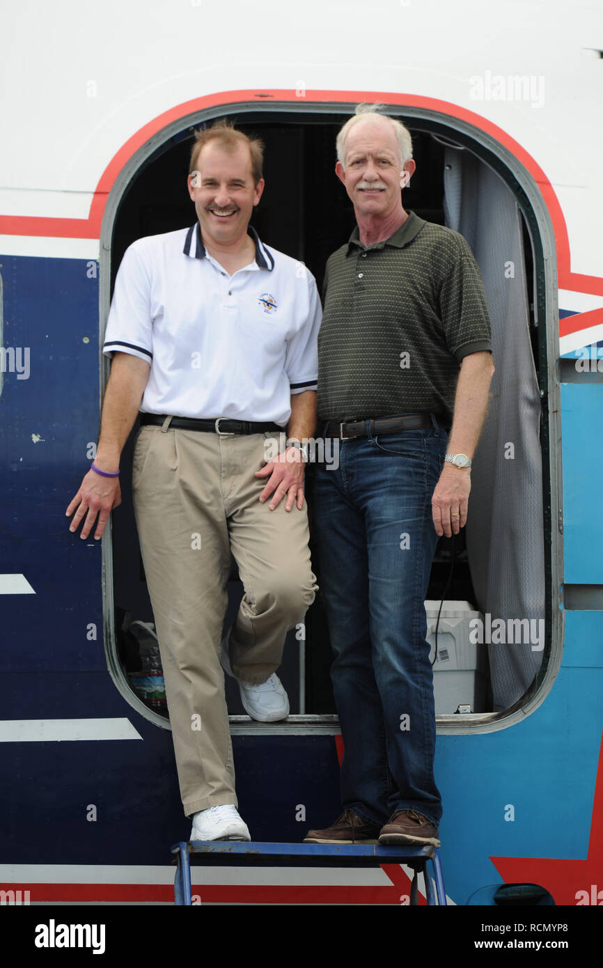 MIAMI, FL - NOVEMBER 17: Captain 'Sully' Sullenberger and Co-pilot Jeff Skiles pose with the Historical 1958 DC7 for a benefit hosted by Historical Flight Foundation. Chesley Burnett 'Sully' Sullenberger, III (born January 23, 1951) is a retired airline captain and aviation safety consultant. He was hailed as a national hero in the United States when he successfully executed an emergency water landing of US Airways Flight 1549 in the Hudson River off Manhattan, New York City, after the aircraft was disabled by striking a flock of Canada geese during its initial climb out of LaGuardia Airport o Stock Photo