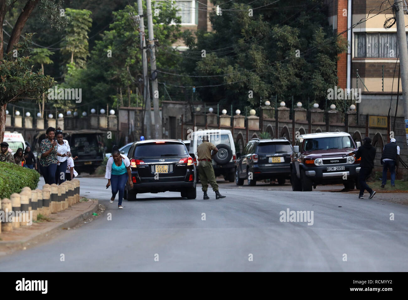 Nairobi, Kenya. 15th Jan, 2019. People are seen near the site of an attack at an upmarket hotel and office complex in Nairobi, Kenya, on Jan. 15, 2019. At least three people have been confirmed dead and several others injured following an attack at an upmarket hotel and office complex in Nairobi on Tuesday, police said. Credit: Wang Teng/Xinhua/Alamy Live News Stock Photo