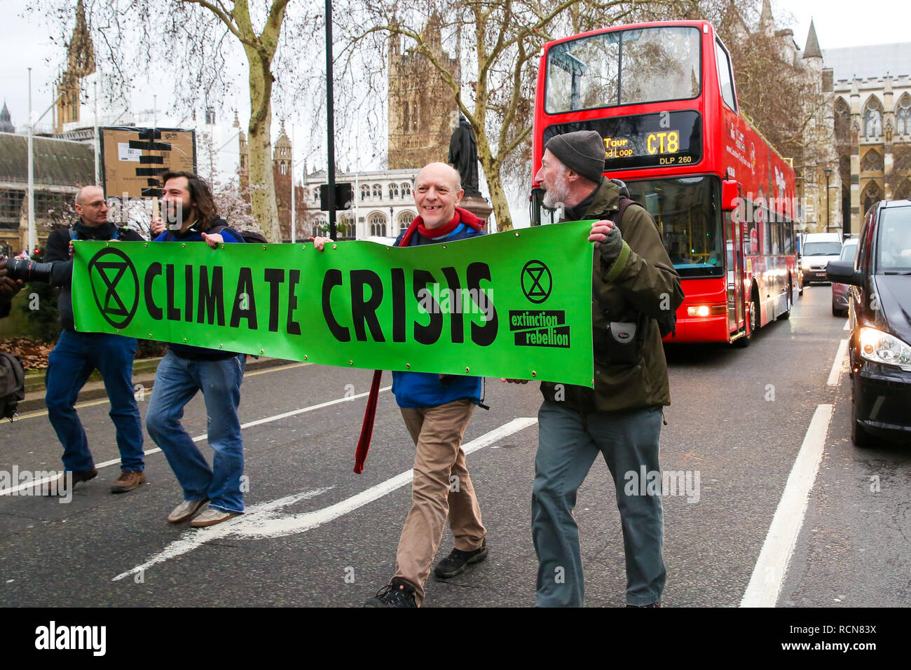 Protesters are seen holding a banner walking in the middle of the road during the protest. A group of climate change activists from Earth Strike UK are seen in Westminster demonstrating to save the Planet. Stock Photo
