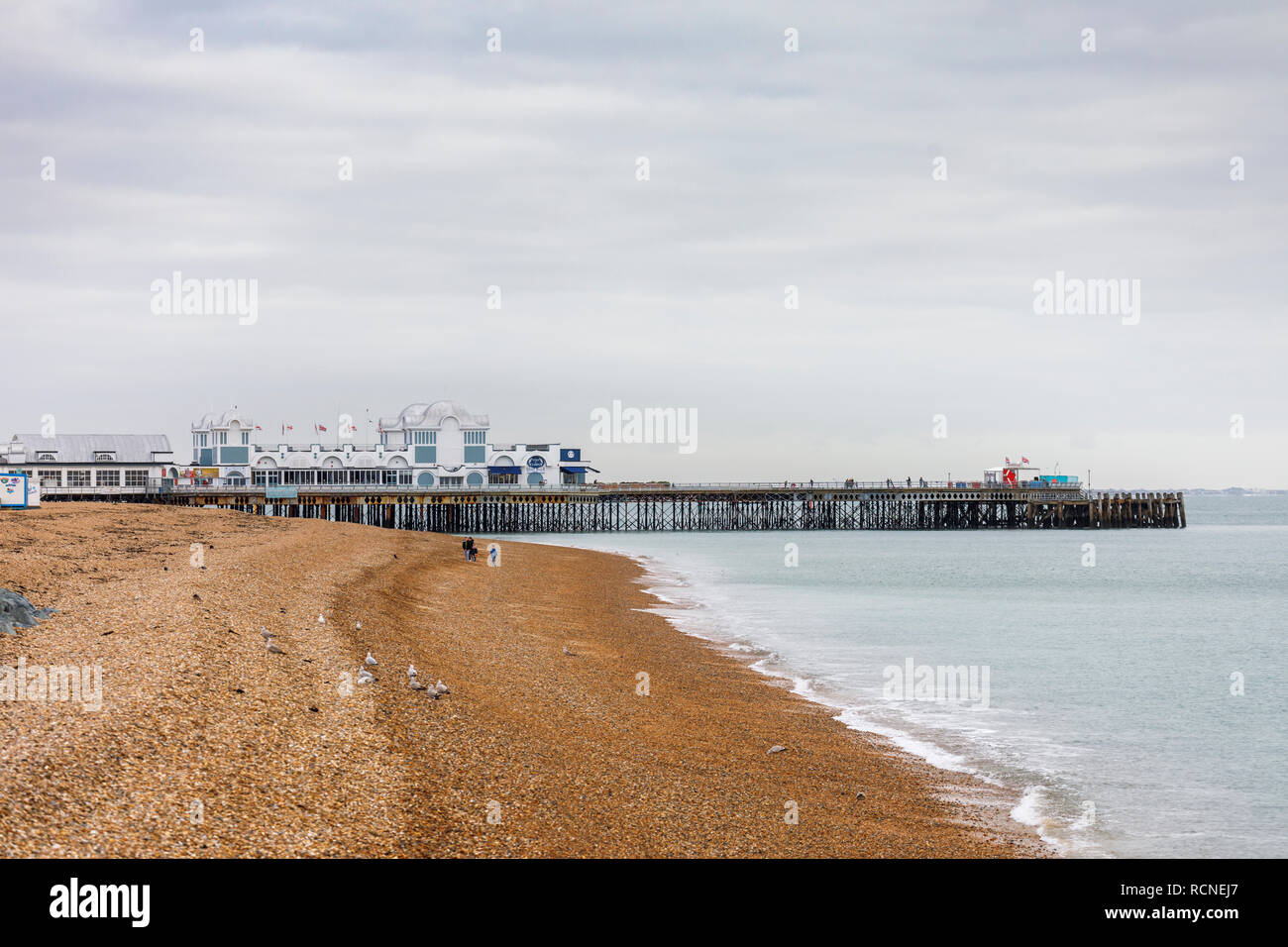 Seafront shoreline view of Victorian South Parade Pier and stony shingle beach, Southsea, Portsmouth, south coast England, UK in low season Stock Photo