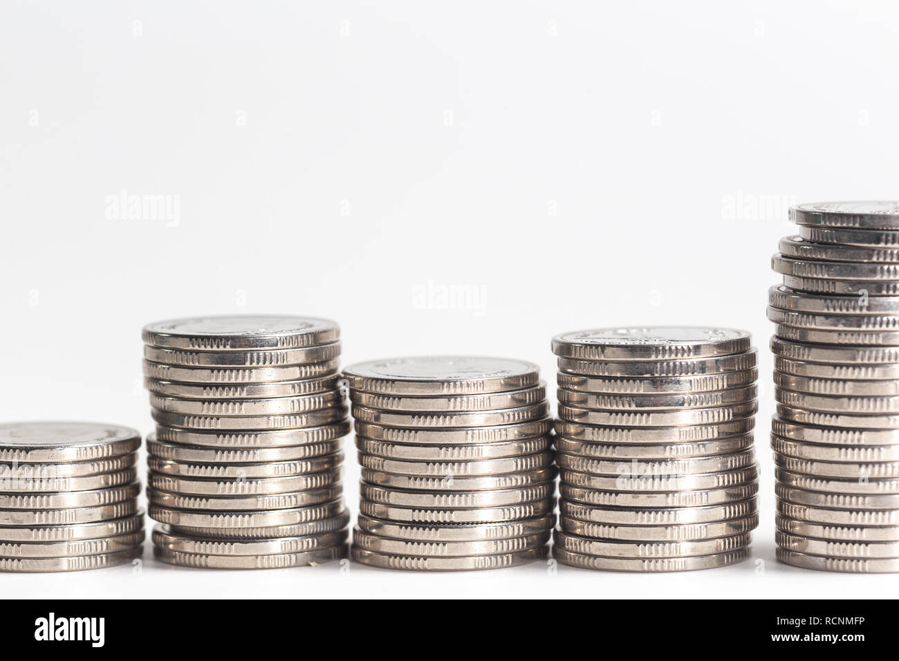 Pile of silver coins on white background Stock Photo - Alamy