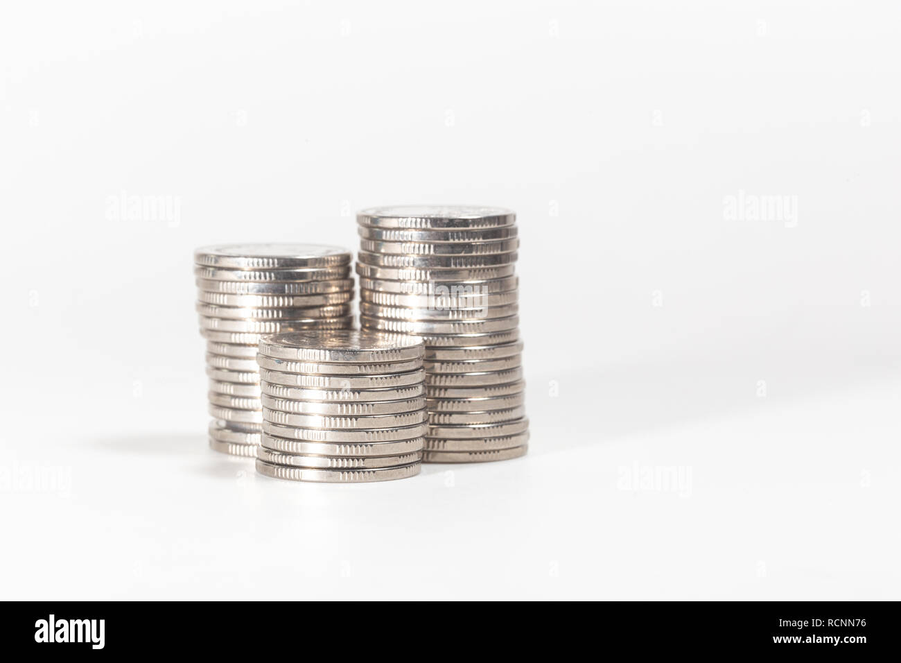 Pile of silver coins on white background Stock Photo - Alamy