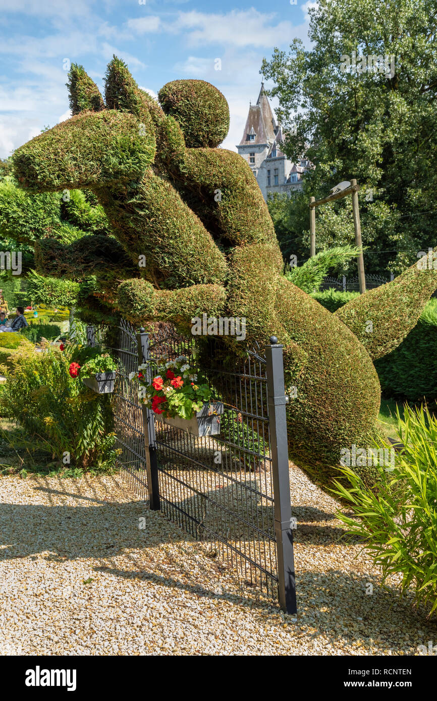 Topiary of horse and riding jumping over fence, Parc des Topiaires, Durbuy, Belgium Stock Photo