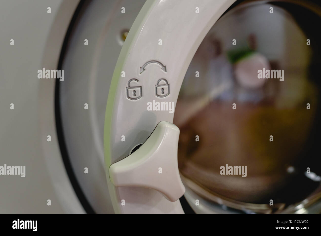 Open doors of industrial washing machines in a public laundry, door