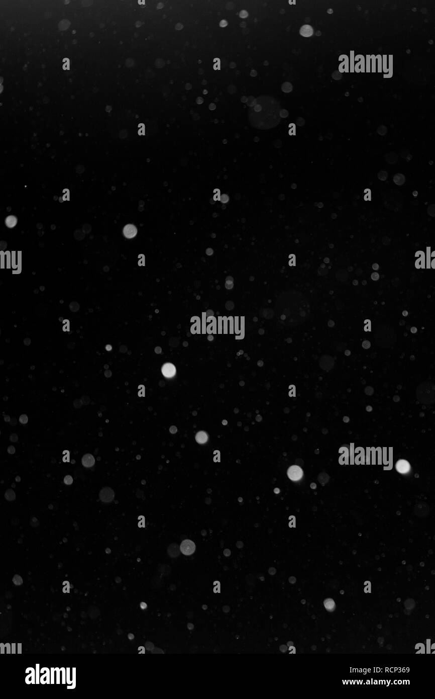 a bokeh of white snow on a black background 2018 Stock Photo - Alamy
