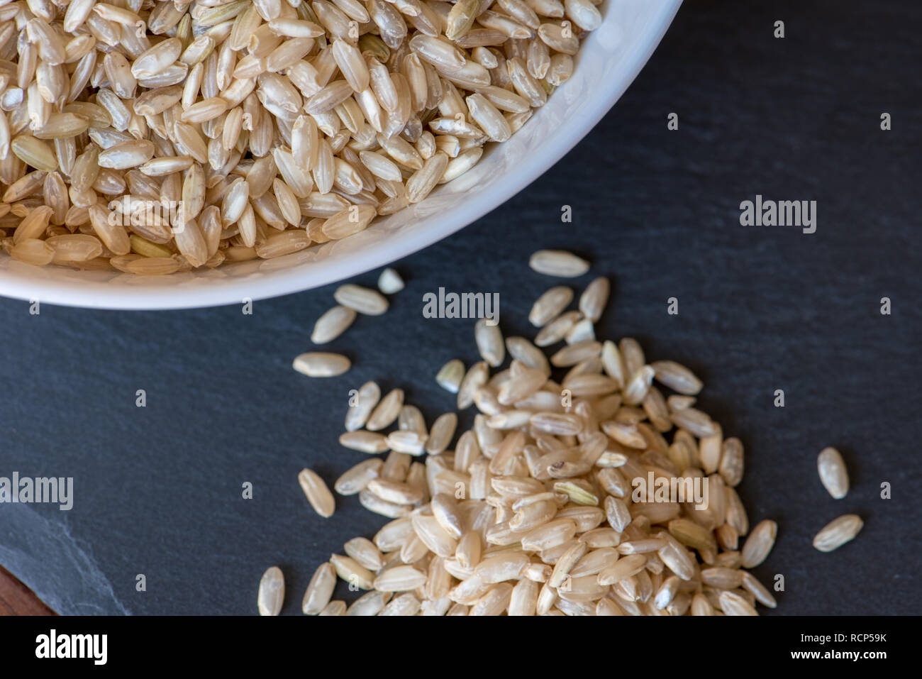 Slate Rice brown rice in a white bowl on a slate board, macrobiotic food, healthy ...