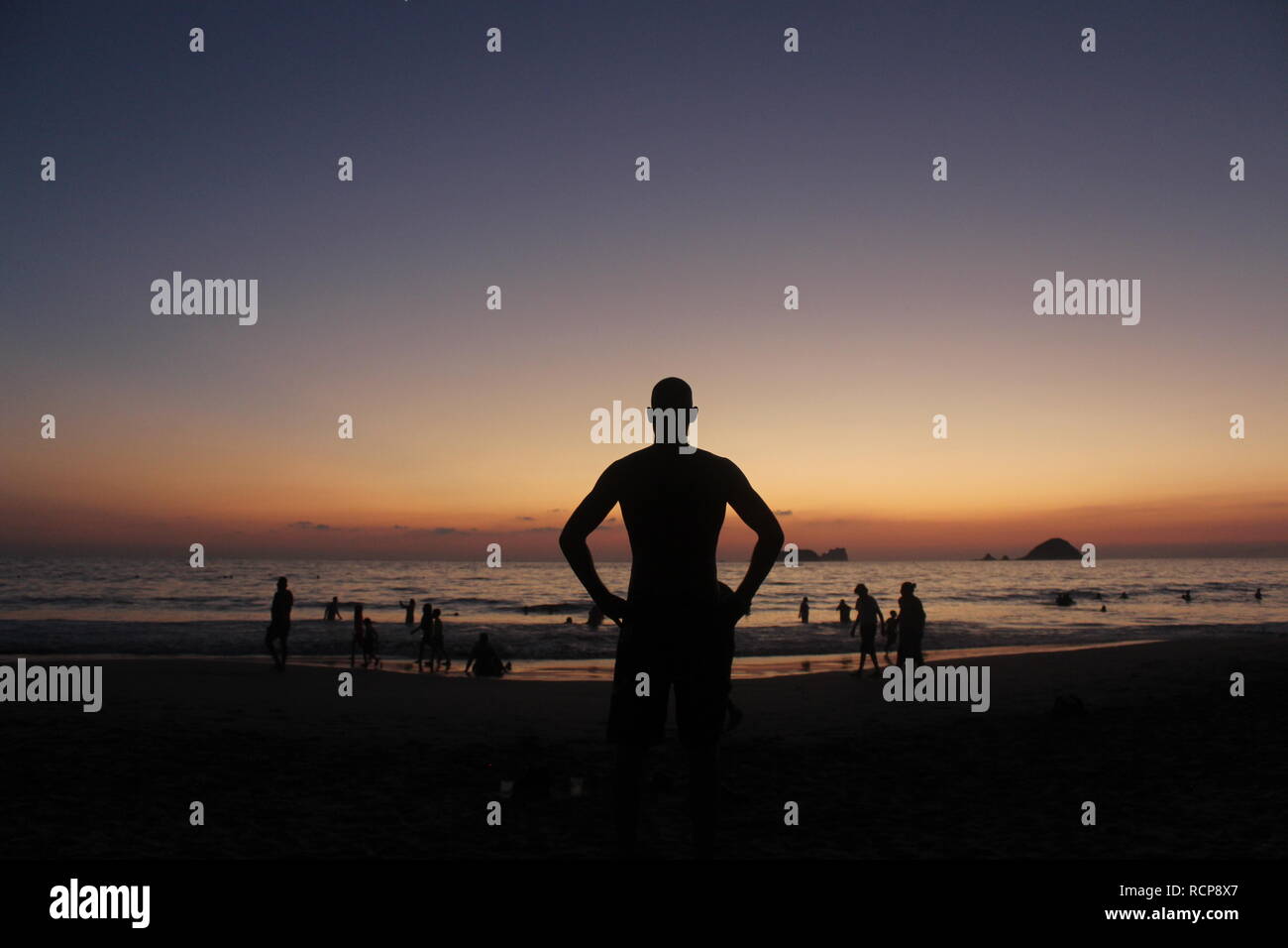 Man watching the sunset Stock Photo - Alamy