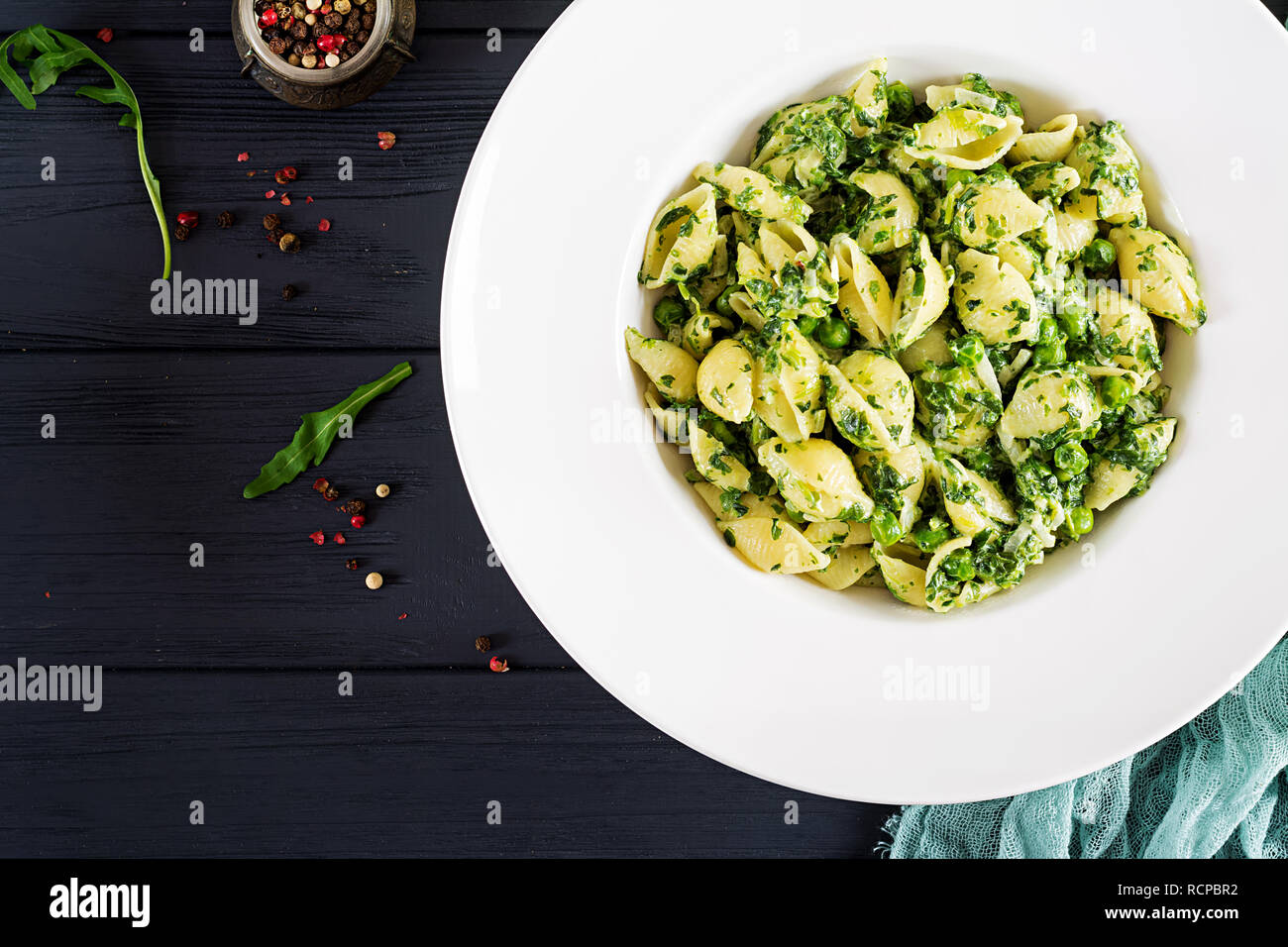 Conchiglie pasta with spinach and green pea pesto. Italian Cuisine