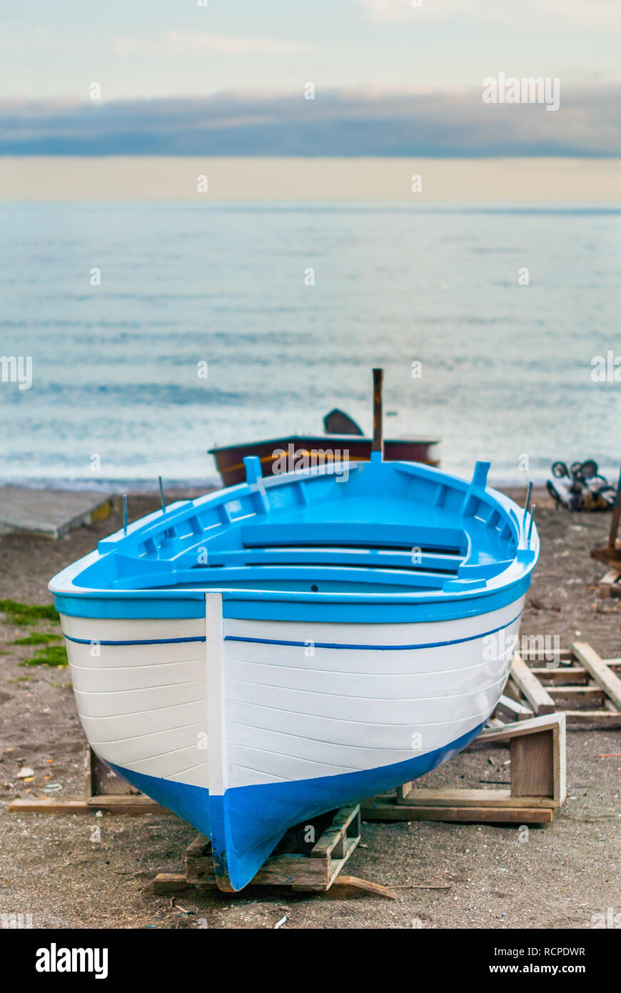 Portrait of a blue and white fishing boat, waiting to cross the sea ...