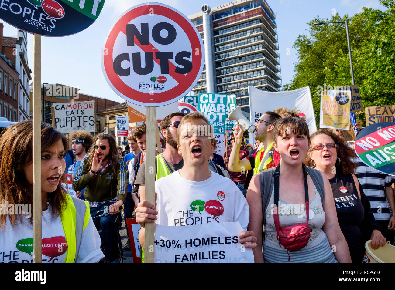 Protesters carrying anti-austerity placards and signs are pictured taking part in an anti-austerity protest march and demonstration in Bristol. Stock Photo