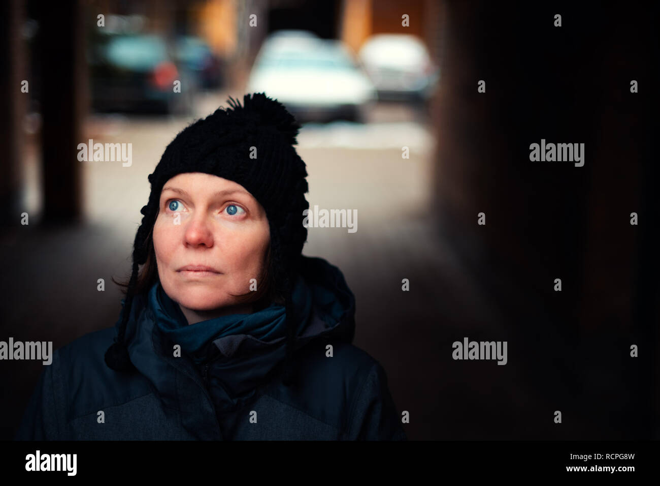 Beautiful hopeful adult caucasian woman portrait on the street on cold winter day Stock Photo