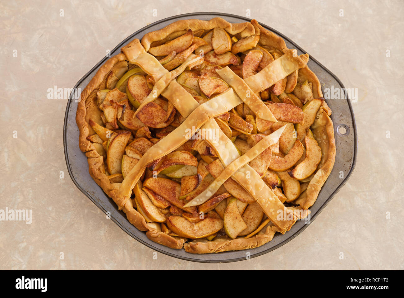 homemade yellow and green apple pie with just a few strips of top crust Stock Photo