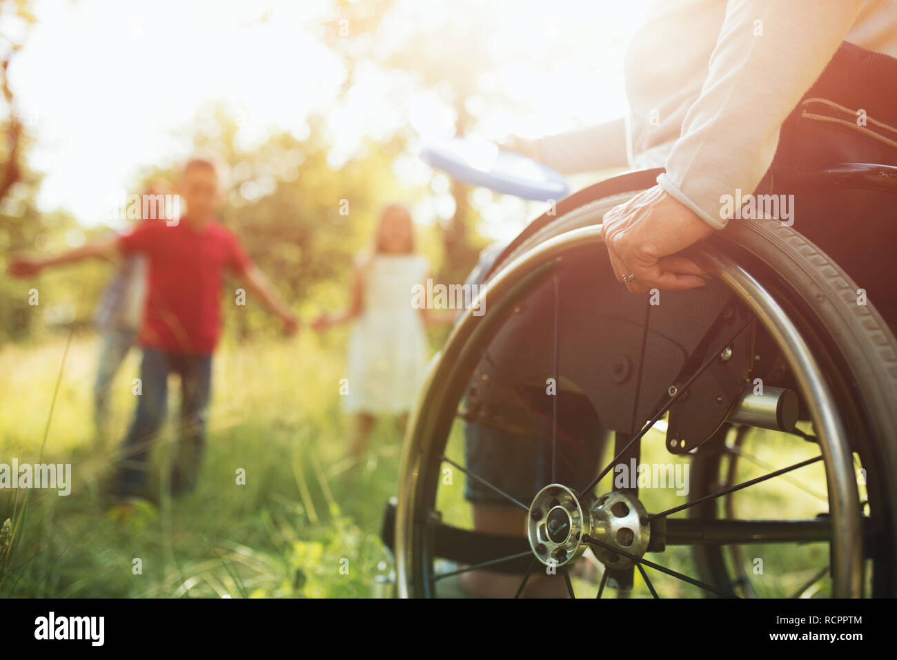 Close-up view on the wheels of a wheelchair. Bright Stock Photo