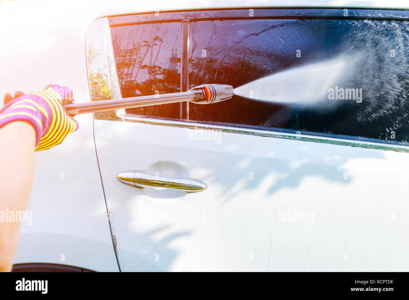 Manual car wash with pressurized water outside. Summer Car Washing