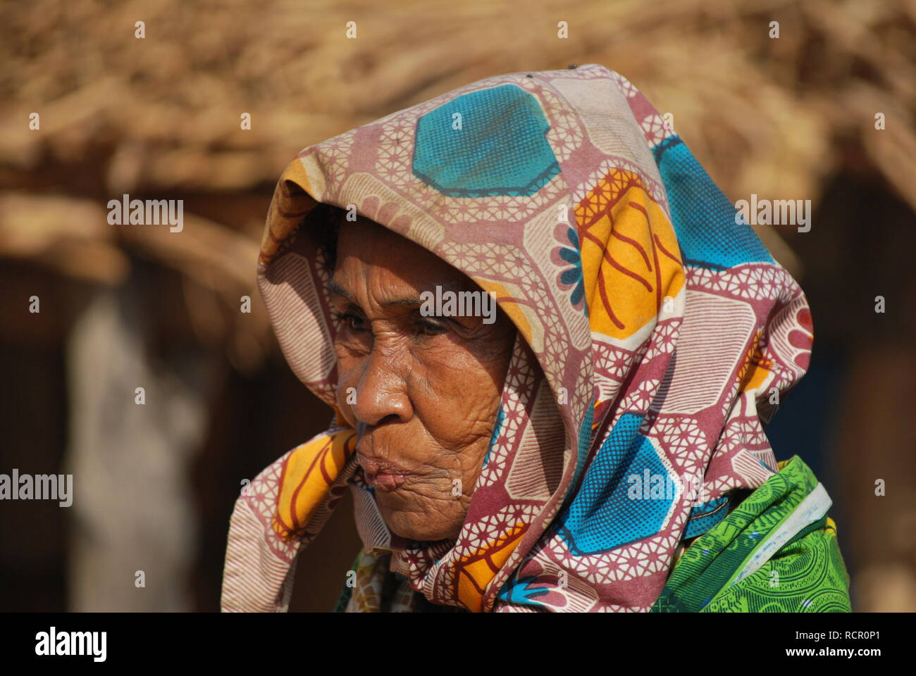 A weatherbeaten old woman at home in her village in Niger, Africa