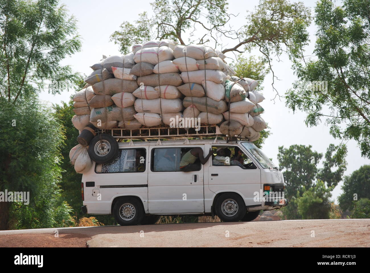Africa Burkina Faso View Of Overloaded African Taxi With People Sitting On  Roof High-Res Stock Photo - Getty Images