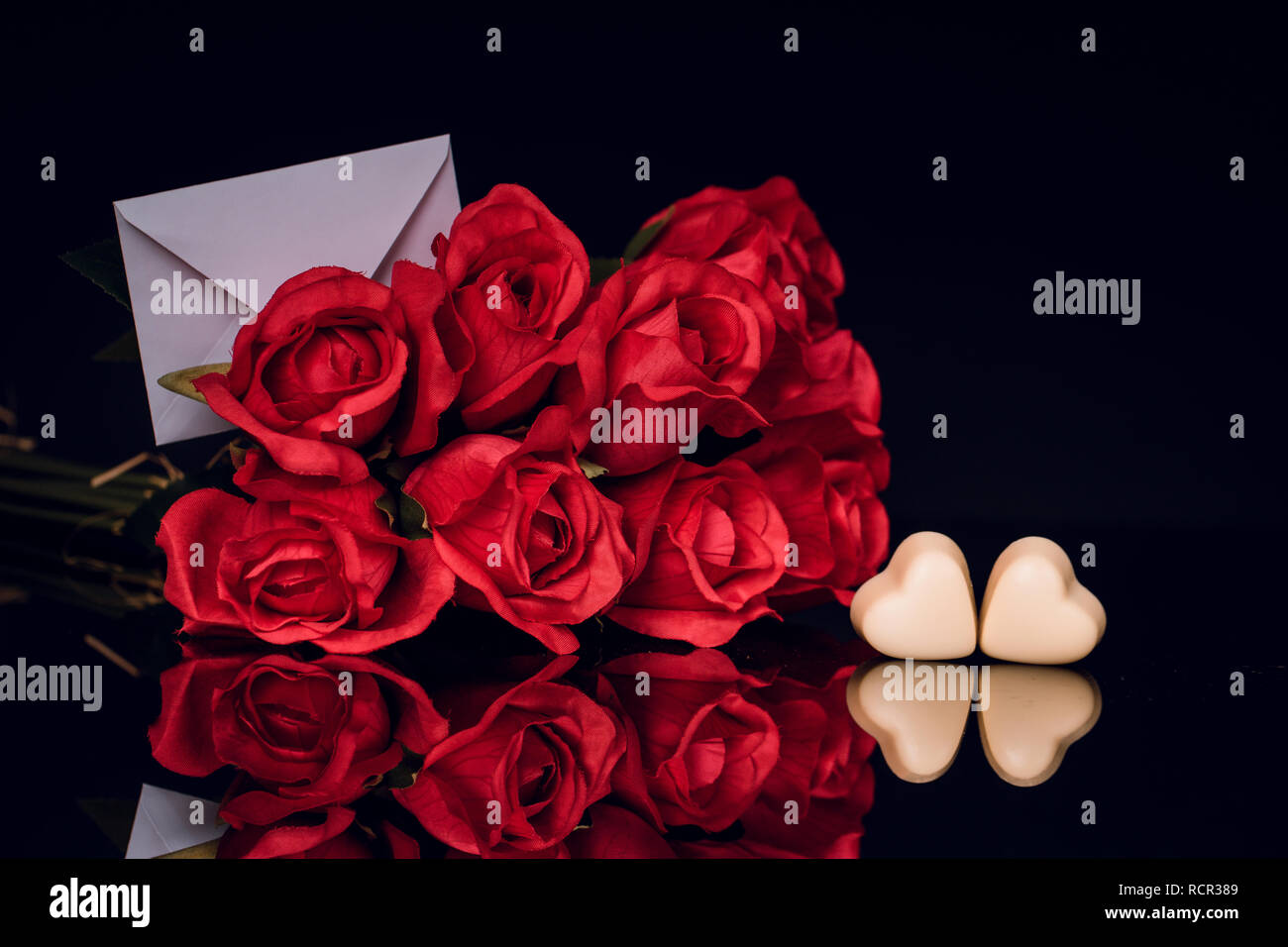 Valentines day greeting card with red roses and heart shaped chocolates ...