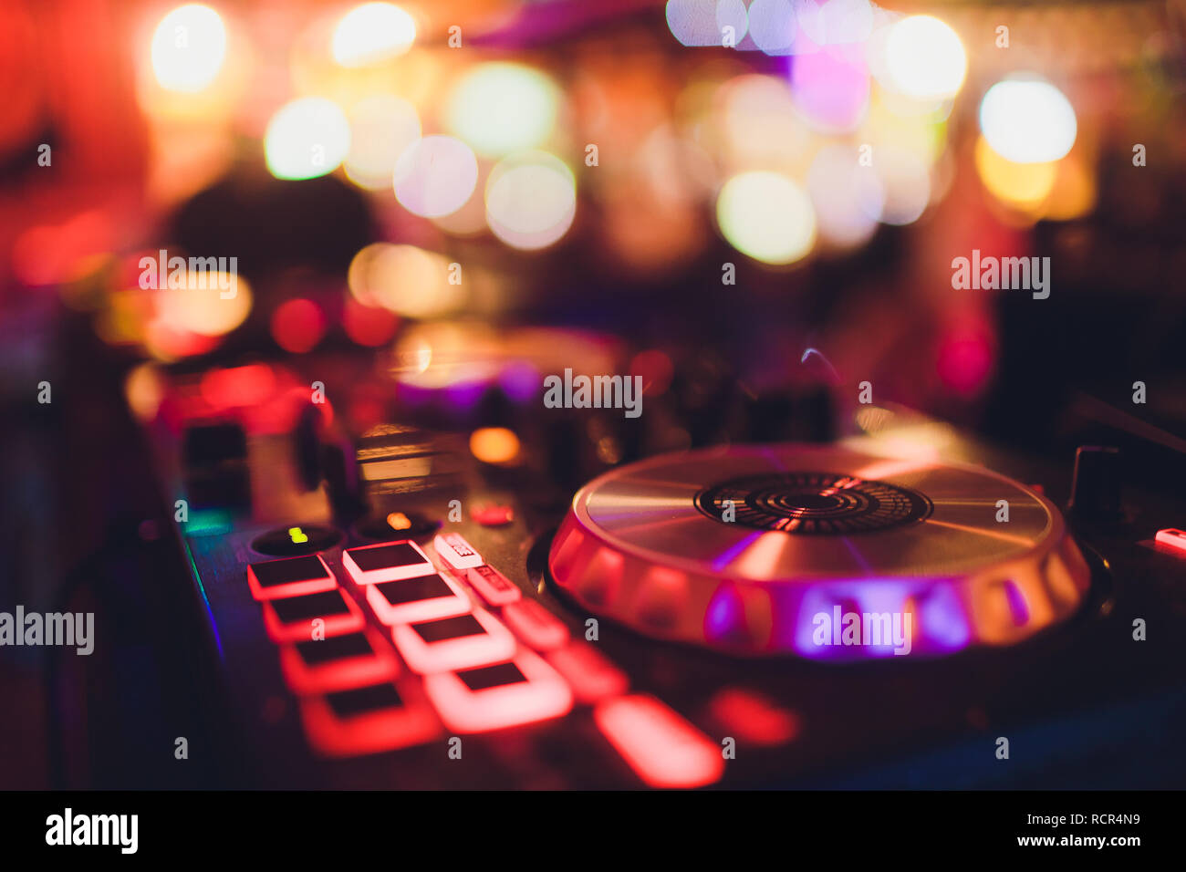 Digital midi controller panel with colorful disco light, Dj turn table