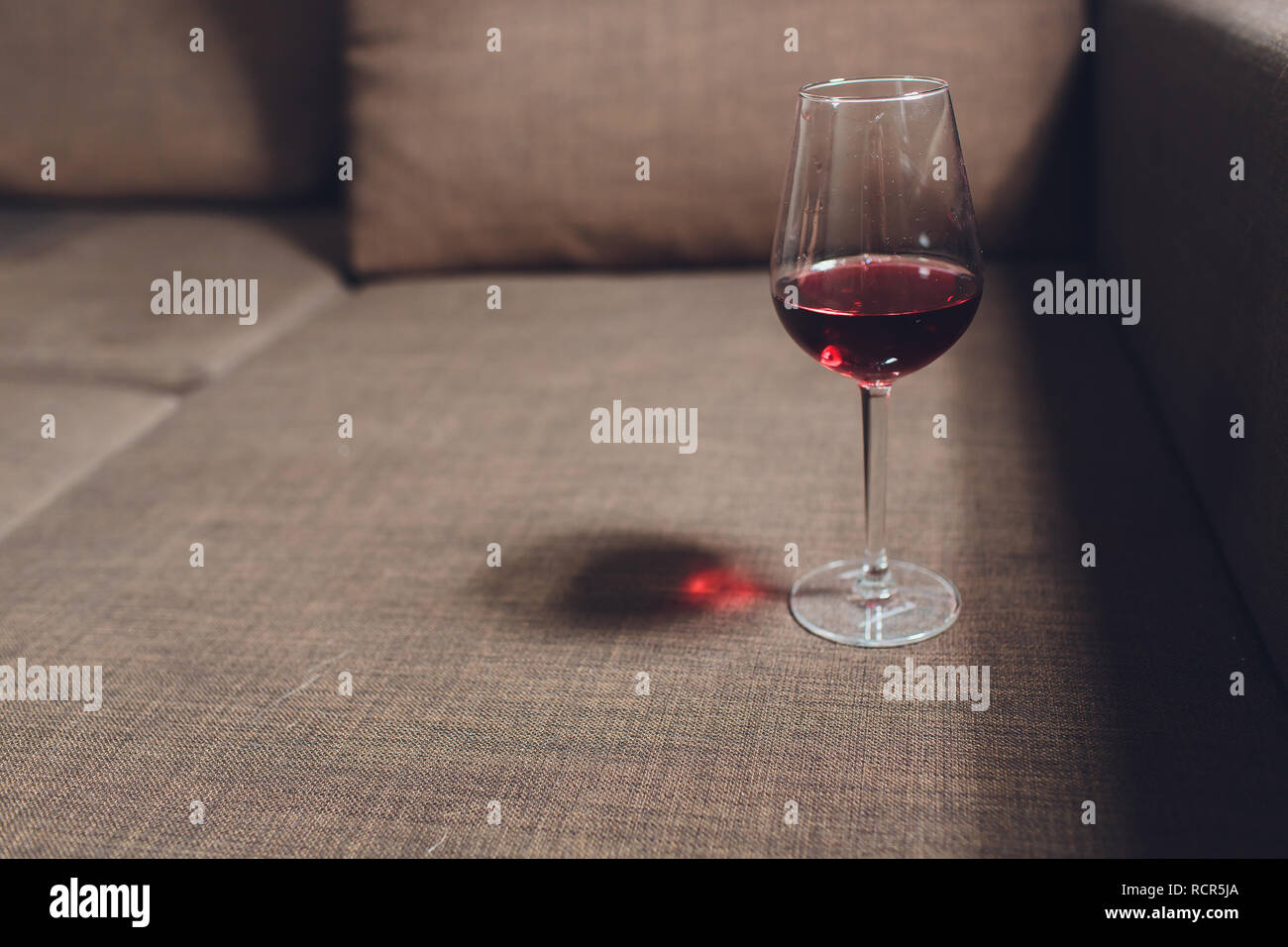 Red Wine Spilled On A Grey Couch Sofa Stock Photo 231619986 Alamy