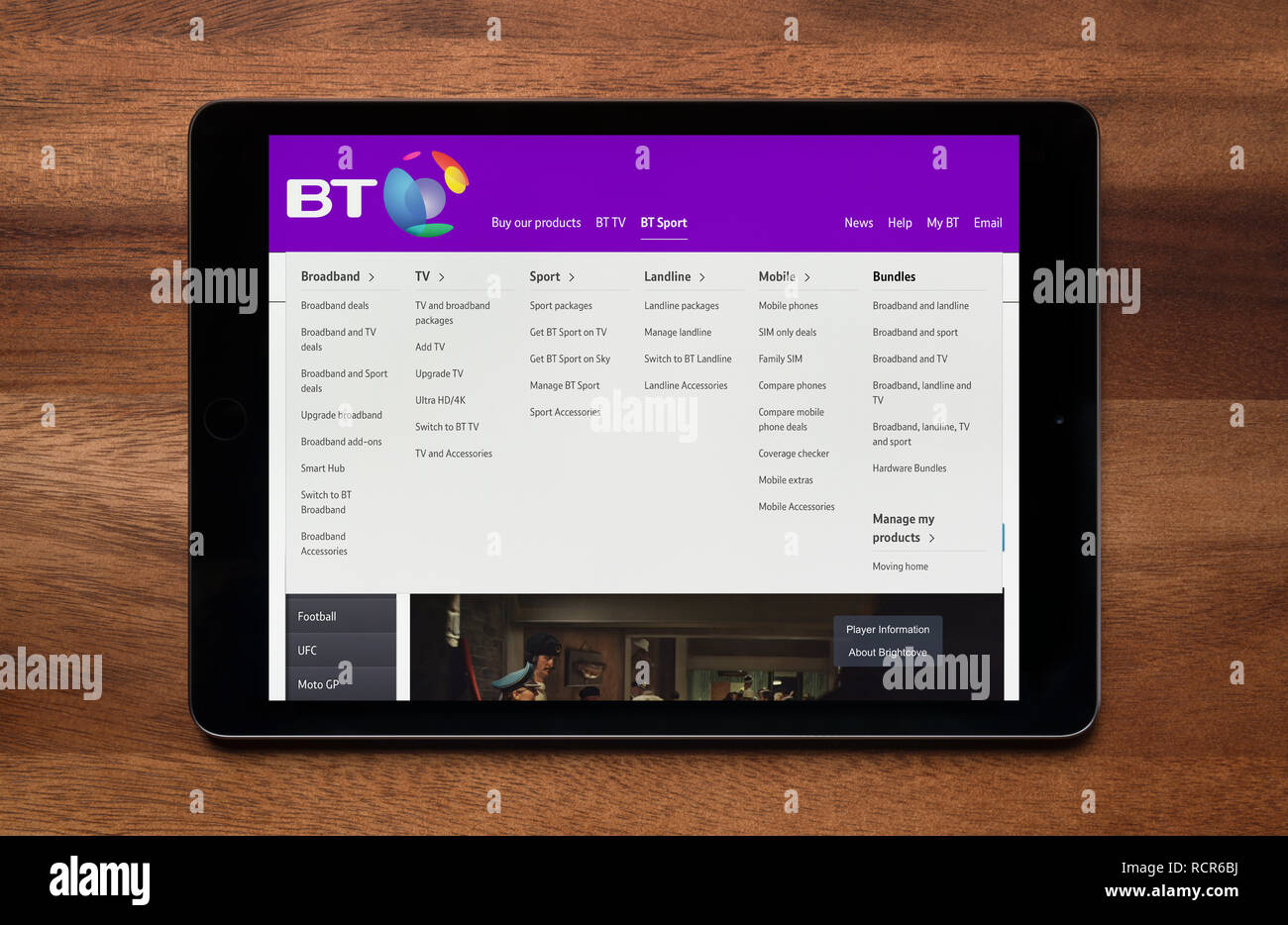 The website of BT is seen on an iPad tablet, which is resting on a wooden table (Editorial use only). Stock Photo