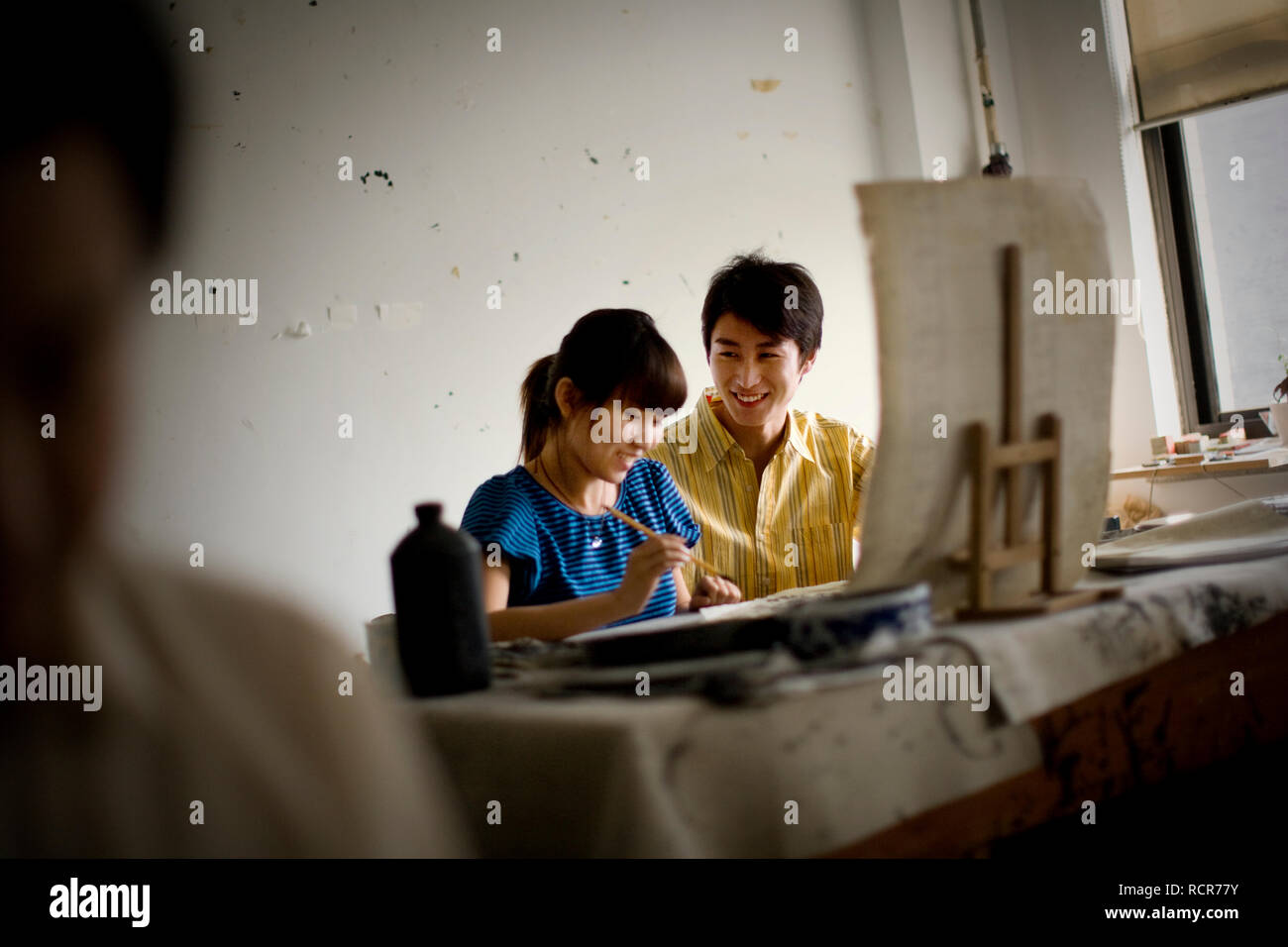 Teenage girl and boy painting in an art room Stock Photo - Alamy